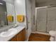 Well-lit bathroom featuring a vanity sink, with a shower-tub combination with glass doors at 1302 Lexington Trl, Greenfield, IN 46140