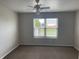 Neutral bedroom featuring a ceiling fan with lighting and a window at 1302 Lexington Trl, Greenfield, IN 46140