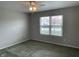 Neutral bedroom featuring a ceiling fan with lighting and a window at 1302 Lexington Trl, Greenfield, IN 46140