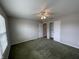Spacious bedroom with neutral walls, a ceiling fan, and access to a walk-in closet at 1302 Lexington Trl, Greenfield, IN 46140