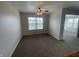 Neutral dining room featuring a ceiling fan with decorative lighting and a window at 1302 Lexington Trl, Greenfield, IN 46140
