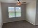 Neutral dining room featuring a ceiling fan with decorative lighting and a window at 1302 Lexington Trl, Greenfield, IN 46140