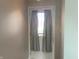 Bright front door with security features and neutral curtains at 1302 Lexington Trl, Greenfield, IN 46140