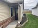 Protected front entrance with manicured landscaping and secure yard at 1302 Lexington Trl, Greenfield, IN 46140