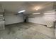 Spacious garage with ample lighting and storage shelves, ready for organization and projects at 1302 Lexington Trl, Greenfield, IN 46140