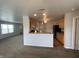 Open-concept kitchen with breakfast bar, granite counters, wood cabinets, and modern appliances at 1302 Lexington Trl, Greenfield, IN 46140
