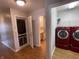 Convenient laundry area with red washer and dryer set inside the house near the bathroom at 1302 Lexington Trl, Greenfield, IN 46140