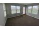 Bright room featuring neutral paint and multiple windows overlooking the fenced yard at 1302 Lexington Trl, Greenfield, IN 46140