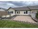 Inviting brick patio with flower beds creating a perfect spot for outdoor relaxation and entertaining at 1302 Lexington Trl, Greenfield, IN 46140