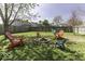 Large backyard with a fire pit and Adirondack chairs, ideal for outdoor gatherings at 1328 Osprey Way, Greenwood, IN 46143