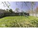 Large backyard with a wooden fence and playground, offering a great space for to play at 1328 Osprey Way, Greenwood, IN 46143