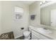 Clean half bathroom featuring a vanity with a sink, a toilet, and a window providing natural light at 1328 Osprey Way, Greenwood, IN 46143