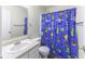 Cheerful bathroom featuring a vanity, a toilet, and a vibrant decorative shower curtain at 1328 Osprey Way, Greenwood, IN 46143
