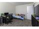 A cozy bedroom with a single bed and a desk, illuminated by natural light at 1328 Osprey Way, Greenwood, IN 46143