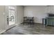 Cozy dining area with modern flooring, a door to the outside, and a view into the kitchen at 1328 Osprey Way, Greenwood, IN 46143