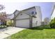 This two-story home boasts a spacious two-car garage and a well-manicured lawn, presenting a tidy exterior at 1328 Osprey Way, Greenwood, IN 46143