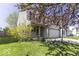 Delightful home with a blooming tree, a covered porch, and a two-car garage set in a lush, green lawn at 1328 Osprey Way, Greenwood, IN 46143
