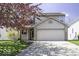 Charming two-story home featuring a two-car garage, landscaped yard and blooming tree in a well-maintained neighborhood at 1328 Osprey Way, Greenwood, IN 46143