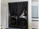 Convenient laundry area with modern washer and dryer, hidden behind a stylish curtain at 1328 Osprey Way, Greenwood, IN 46143