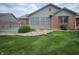 Home exterior with a deck, manicured lawn and a rock garden with colorful spring blossoms at 1330 Country Creek Cir, Shelbyville, IN 46176