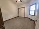 A bedroom bathed in natural light, featuring tile flooring and a closet at 1330 Country Creek Cir, Shelbyville, IN 46176
