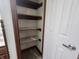 A closet featuring wooden shelves, complemented by wood trim, providing practical storage options at 1330 Country Creek Cir, Shelbyville, IN 46176