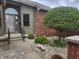 Arched entry way to front door surrounded by landscaped stones, trees and bushes at 1330 Country Creek Cir, Shelbyville, IN 46176
