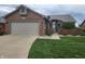 Charming brick home featuring a well-manicured lawn and attached two car garage at 1330 Country Creek Cir, Shelbyville, IN 46176