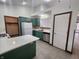 Bright kitchen with stainless appliances, white counters, and green cabinetry at 1330 Country Creek Cir, Shelbyville, IN 46176