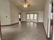 Open living room with tile floor, ceiling fan, and access to the backyard at 1330 Country Creek Cir, Shelbyville, IN 46176