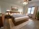 Staged main bedroom featuring a large bed, dresser, and a ceiling fan at 1330 Country Creek Cir, Shelbyville, IN 46176