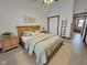 Bedroom with warm wooden furnishings, complemented by light green bedding, and enhanced by natural light at 1330 Country Creek Cir, Shelbyville, IN 46176
