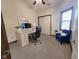 Bright office with desk and accent chair, complemented by natural light from the window at 1330 Country Creek Cir, Shelbyville, IN 46176