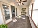 Inviting sunroom with a ceiling fan, sliding doors, and a cozy seating area surrounded by potted plants at 1330 Country Creek Cir, Shelbyville, IN 46176