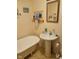 Bright bathroom with vintage soaking tub, pedestal sink, and unique decor at 13346 N Miller Dr, Camby, IN 46113