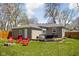 Backyard with a mix of open lawn and deck, perfect for outdoor gatherings at 1355 E 56Th St, Indianapolis, IN 46220