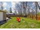 Spacious backyard with fire pit area surrounded by red Adirondack chairs at 1355 E 56Th St, Indianapolis, IN 46220