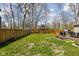 Expansive backyard with lush lawn, mature trees, and a wooden fence at 1355 E 56Th St, Indianapolis, IN 46220