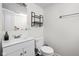 Clean, bright bathroom with white fixtures and modern accents like the open towel rack at 1355 E 56Th St, Indianapolis, IN 46220