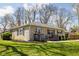 Attractive stone home featuring a welcoming porch, well-manicured lawn, and professional landscaping at 1355 E 56Th St, Indianapolis, IN 46220