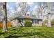 Charming single story home with a stone facade and mature landscaping at 1355 E 56Th St, Indianapolis, IN 46220