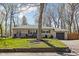 Charming single-story home with stone facade, well-kept landscaping, and attached garage at 1355 E 56Th St, Indianapolis, IN 46220