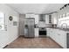 Spacious kitchen featuring stainless steel appliances, white cabinets, and ample counter space at 1355 E 56Th St, Indianapolis, IN 46220