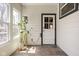 Bright sunroom with slate floors, large windows, and hanging potted plants at 1355 E 56Th St, Indianapolis, IN 46220