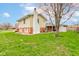 The backyard of this lovely home is spacious with a lush green lawn and mature trees at 1503 Saint John S Ct, Beech Grove, IN 46107