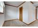 Carpeted room in basement with paneled walls, and a wood-look door at 1503 Saint John S Ct, Beech Grove, IN 46107