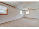 Finished basement with painted paneling, carpet, and natural light from windows at 1503 Saint John S Ct, Beech Grove, IN 46107