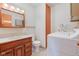 Cozy bathroom featuring a wood vanity, mirror and a convenient washer and dryer for added functionality at 1503 Saint John S Ct, Beech Grove, IN 46107