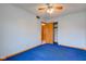 Blue carpeted bedroom with ceiling fan, closet and adjoining doorway that provides a comfortable flow at 1503 Saint John S Ct, Beech Grove, IN 46107