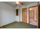 Green carpeted bedroom with closet and fan. An open doorway leads to another room at 1503 Saint John S Ct, Beech Grove, IN 46107
